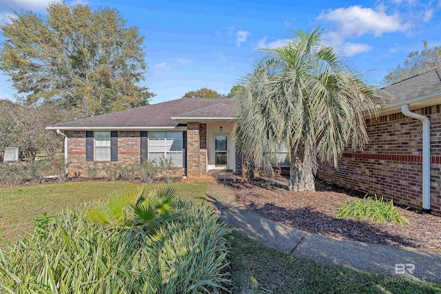 ranch-style home featuring a front yard