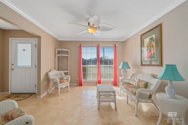 living area featuring a textured ceiling, ceiling fan, light tile patterned flooring, and crown molding