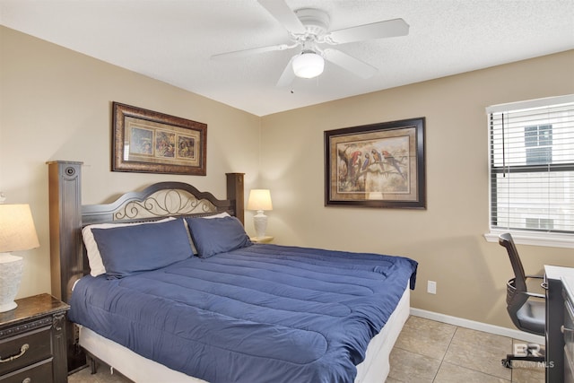 952 W Beach Blvd Unit 210, Gulf Shores, AL 36542 - bedroom with light tile patterned flooring, baseboards, ceiling fan, and a textured ceiling
