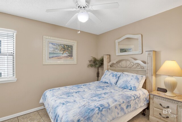 952 W Beach Blvd Unit 210, Gulf Shores, AL 36542 - bedroom featuring multiple windows, light tile patterned floors, baseboards, and a ceiling fan