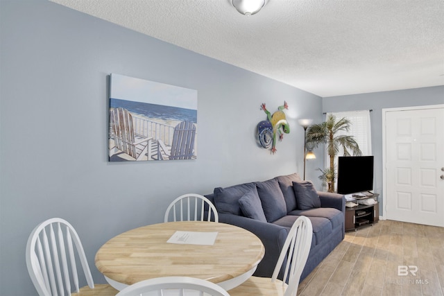952 W Beach Blvd Unit 210, Gulf Shores, AL 36542 - dining space with a textured ceiling and light wood finished floors