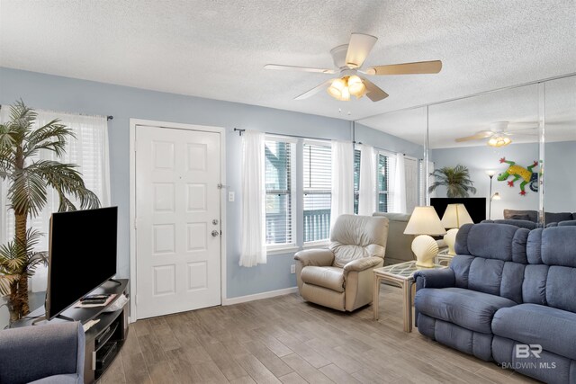 952 W Beach Blvd Unit 210, Gulf Shores, AL 36542 - living area with a ceiling fan, a textured ceiling, light wood-style floors, and baseboards