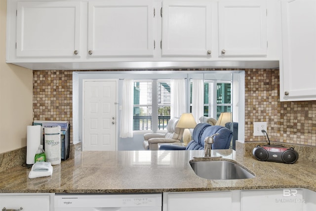 952 W Beach Blvd Unit 210, Gulf Shores, AL 36542 - kitchen featuring a sink, white cabinetry, decorative backsplash, and light stone counters
