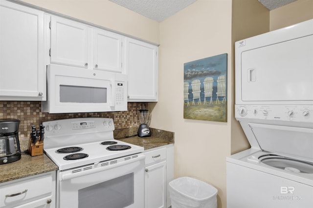 952 W Beach Blvd Unit 210, Gulf Shores, AL 36542 - kitchen with white appliances, stacked washer / dryer, white cabinets, decorative backsplash, and a textured ceiling