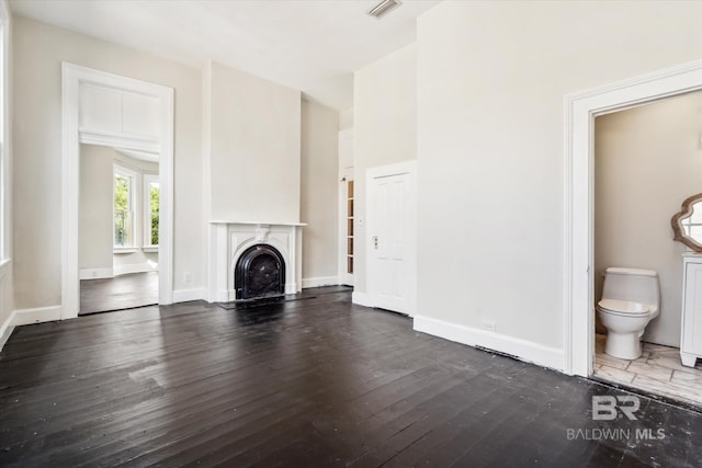 unfurnished living room featuring dark wood-type flooring