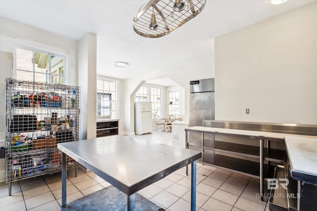 kitchen with white fridge and light tile patterned floors