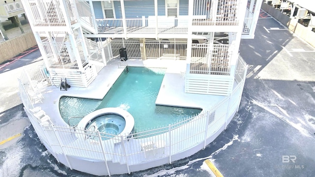 view of swimming pool featuring a community hot tub