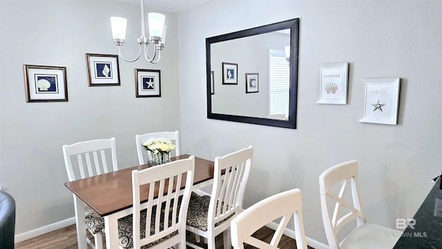 dining room featuring hardwood / wood-style floors and a notable chandelier