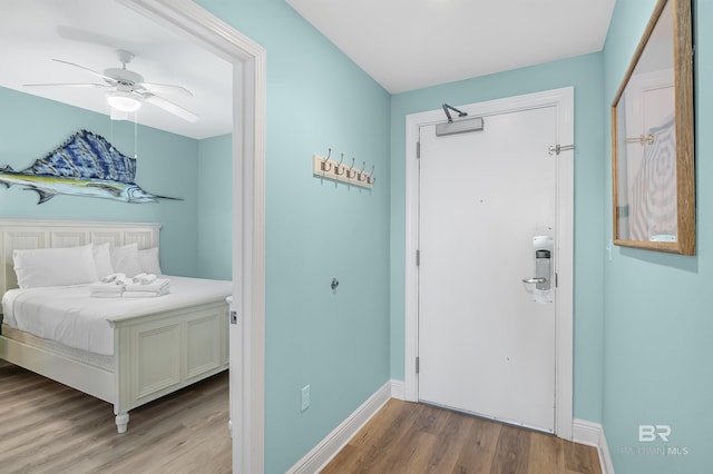 interior space featuring baseboards and wood finished floors