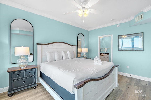 bedroom featuring light wood-style flooring, visible vents, baseboards, and crown molding