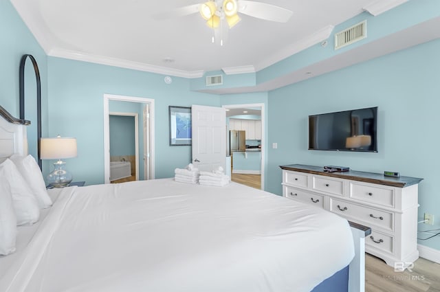 bedroom with freestanding refrigerator, light wood finished floors, visible vents, and crown molding