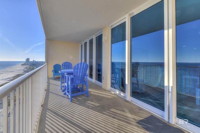 balcony with a water view and a beach view