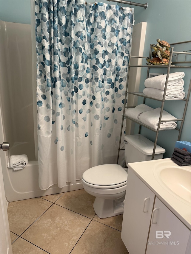 full bathroom featuring tile patterned flooring, toilet, shower / bath combo with shower curtain, and vanity