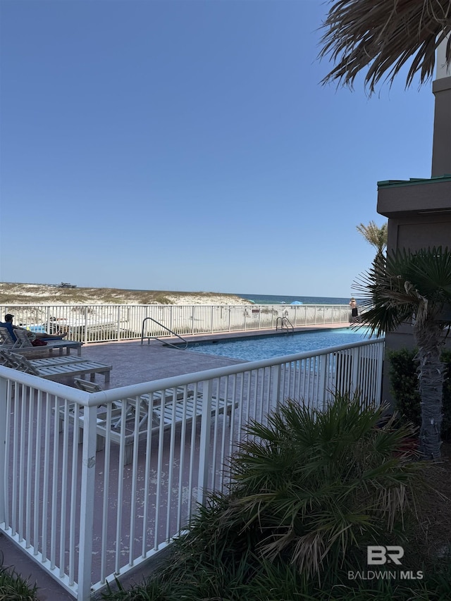 view of pool with a water view