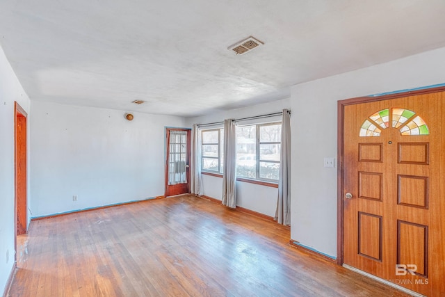 entryway with visible vents, baseboards, and wood finished floors