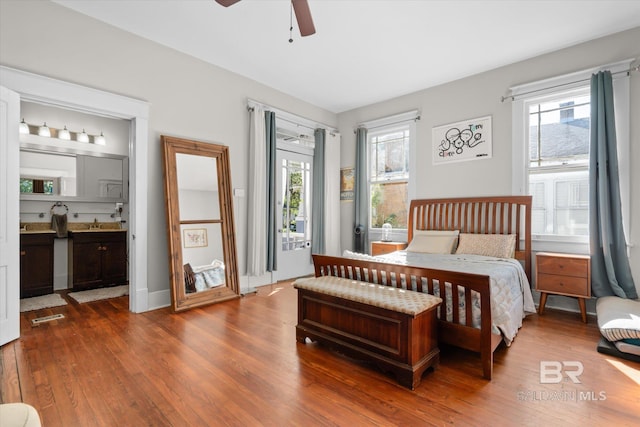 bedroom featuring connected bathroom, wood-type flooring, and ceiling fan