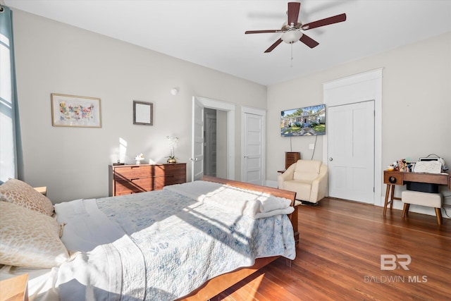 bedroom with dark hardwood / wood-style floors and ceiling fan