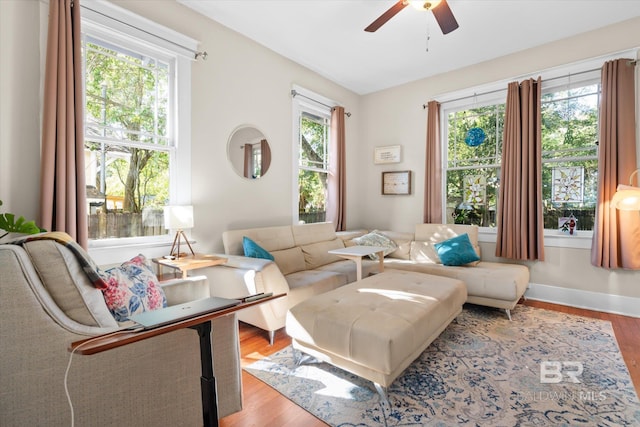 sitting room with wood-type flooring and ceiling fan