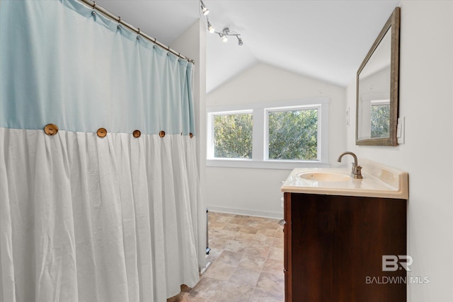 bathroom with vanity and vaulted ceiling