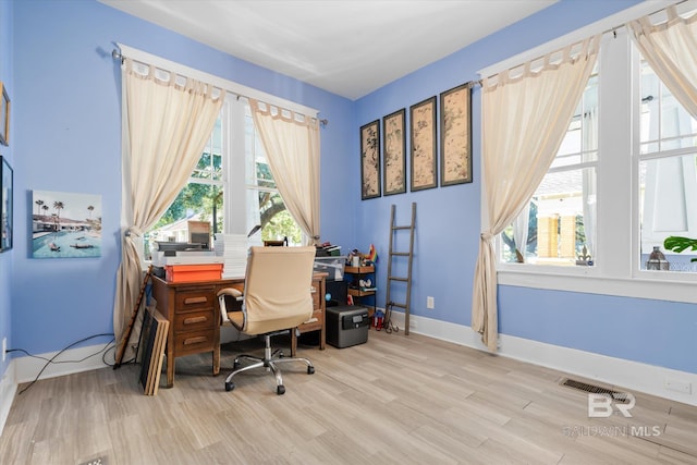 home office with hardwood / wood-style floors