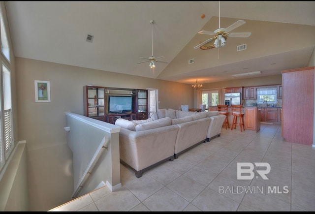 living room featuring high vaulted ceiling, light tile flooring, and ceiling fan