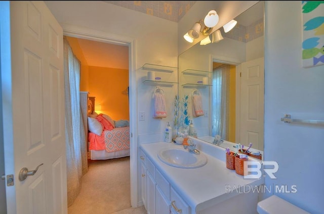 bathroom featuring vanity with extensive cabinet space and toilet