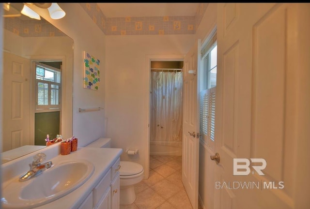 bathroom with vanity with extensive cabinet space, toilet, and tile floors