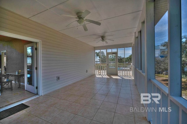 unfurnished sunroom featuring a paneled ceiling and ceiling fan