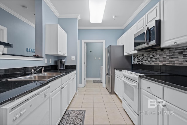 kitchen with light tile patterned floors, tasteful backsplash, appliances with stainless steel finishes, ornamental molding, and white cabinetry