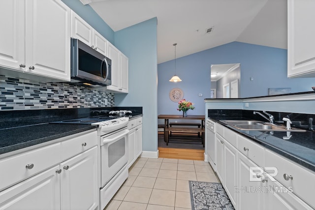 kitchen featuring dark countertops, white appliances, light tile patterned floors, and visible vents