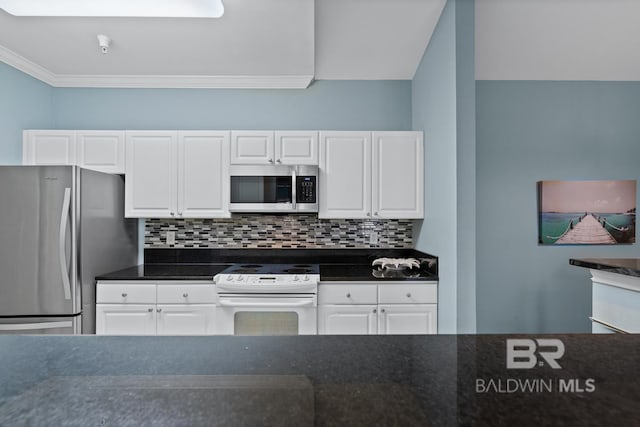 kitchen featuring appliances with stainless steel finishes, white cabinets, and decorative backsplash