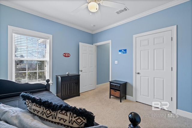 bedroom with carpet floors, crown molding, visible vents, ceiling fan, and baseboards