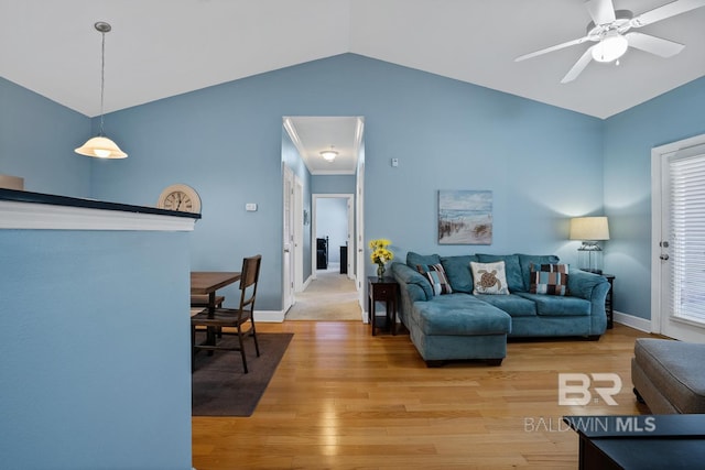 living room with light wood-type flooring, baseboards, a ceiling fan, and lofted ceiling