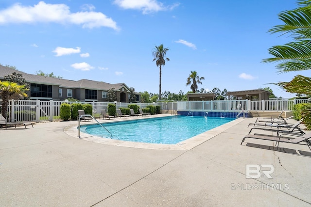 pool featuring fence and a patio