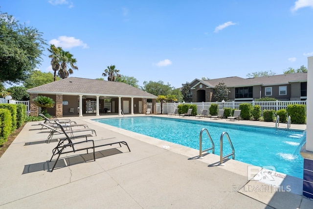 pool featuring a patio and fence