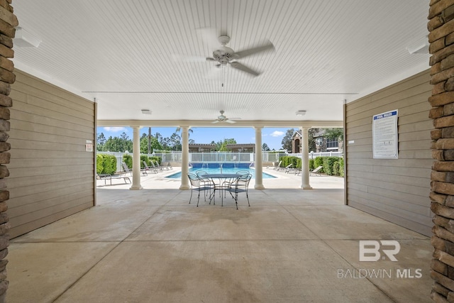 view of patio featuring ceiling fan, a community pool, and fence