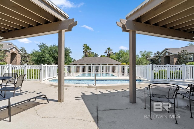 view of patio / terrace with fence and a fenced in pool