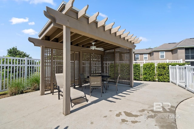 view of patio featuring ceiling fan, outdoor dining space, and fence