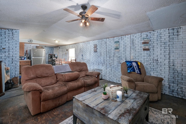 living room with brick wall, a textured ceiling, vaulted ceiling, and ceiling fan