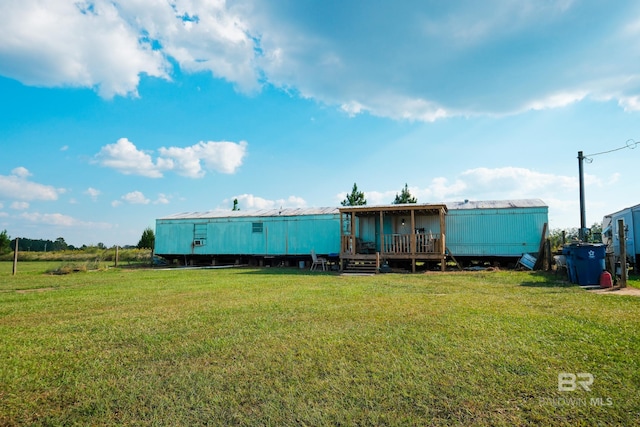 rear view of house featuring a lawn