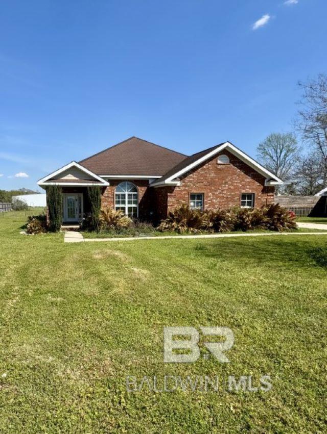 single story home with brick siding and a front lawn