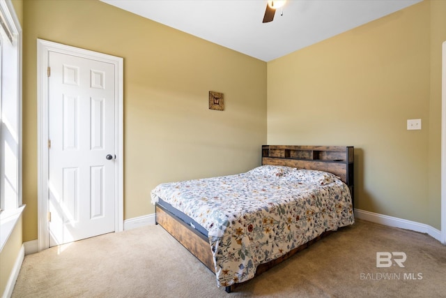 carpeted bedroom with baseboards and ceiling fan