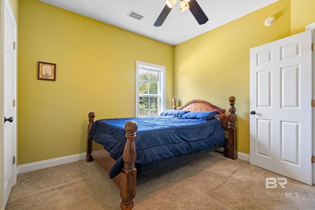 carpeted bedroom with baseboards, ceiling fan, and visible vents