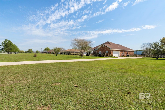 view of yard featuring driveway and an attached garage