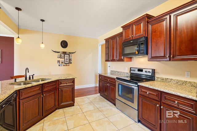 kitchen featuring light stone counters, a sink, hanging light fixtures, light tile patterned floors, and black appliances