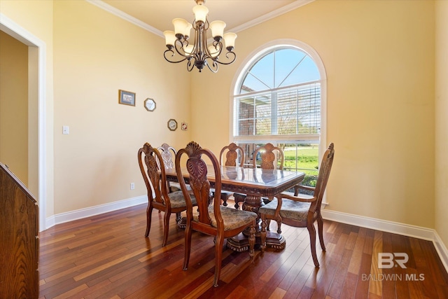 dining room with dark wood-style flooring, crown molding, baseboards, and a chandelier