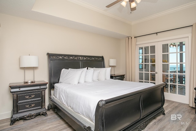 bedroom featuring french doors, wood finished floors, a ceiling fan, and ornamental molding