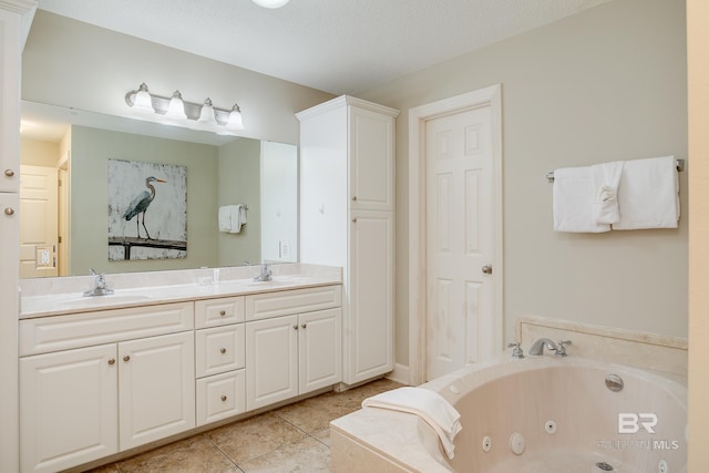 bathroom featuring tile patterned floors, double vanity, a whirlpool tub, and a sink