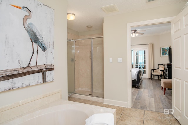 ensuite bathroom with tile patterned flooring, visible vents, a shower stall, a bath, and ensuite bath