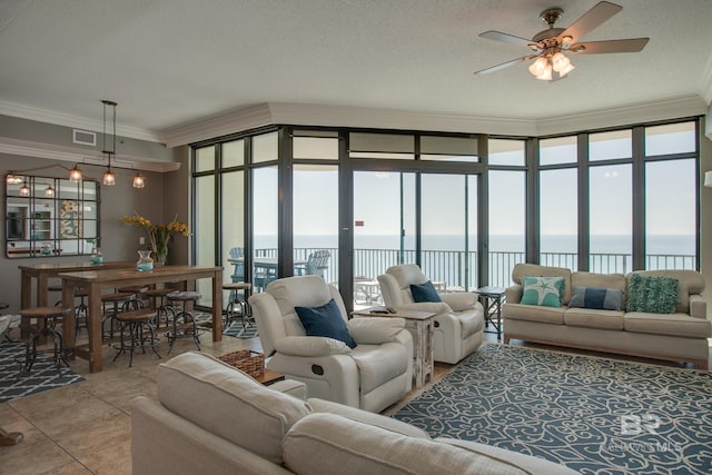 living room featuring visible vents, a water view, a ceiling fan, crown molding, and light tile patterned floors